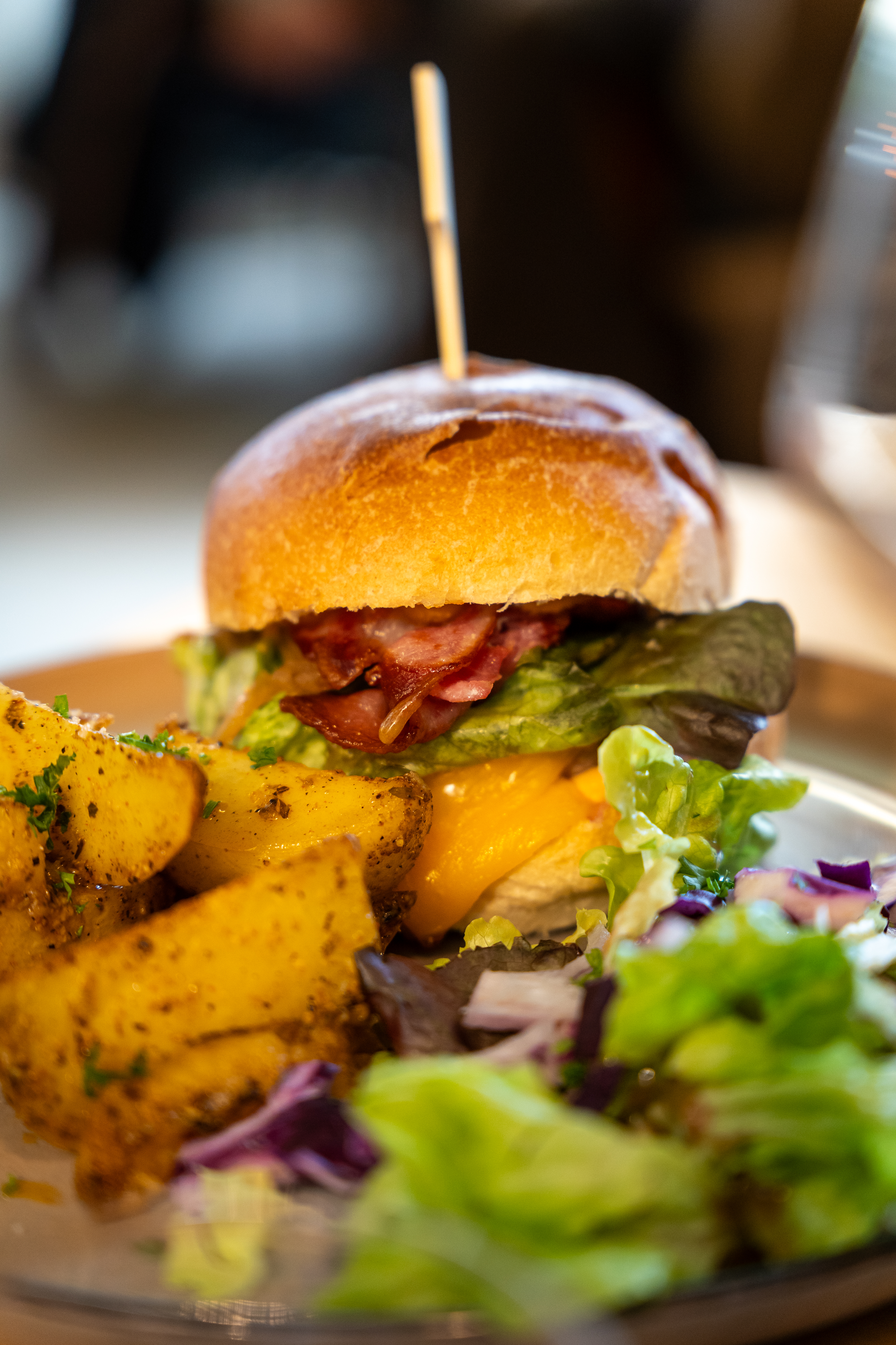 Burger signature maison de L'Accalmie avec frites fraîches et pain frais d'artisan boulanger local